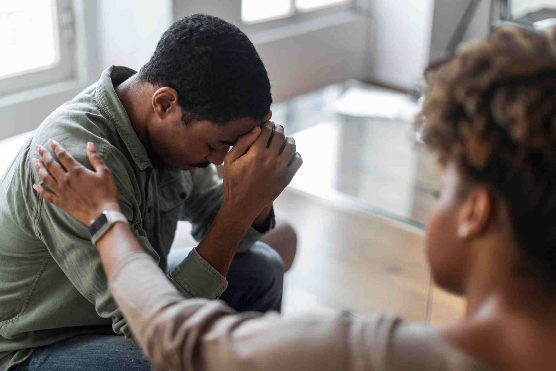 Person experiencing emotional distress while receiving support during a mental health conversation