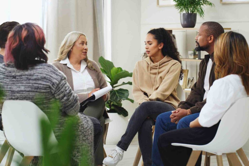 Mental health support group meeting in a bright counseling room