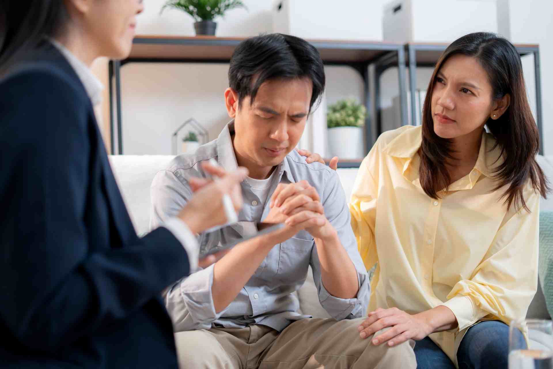 Couple meeting with a therapist during a mental health counseling and emotional support session.