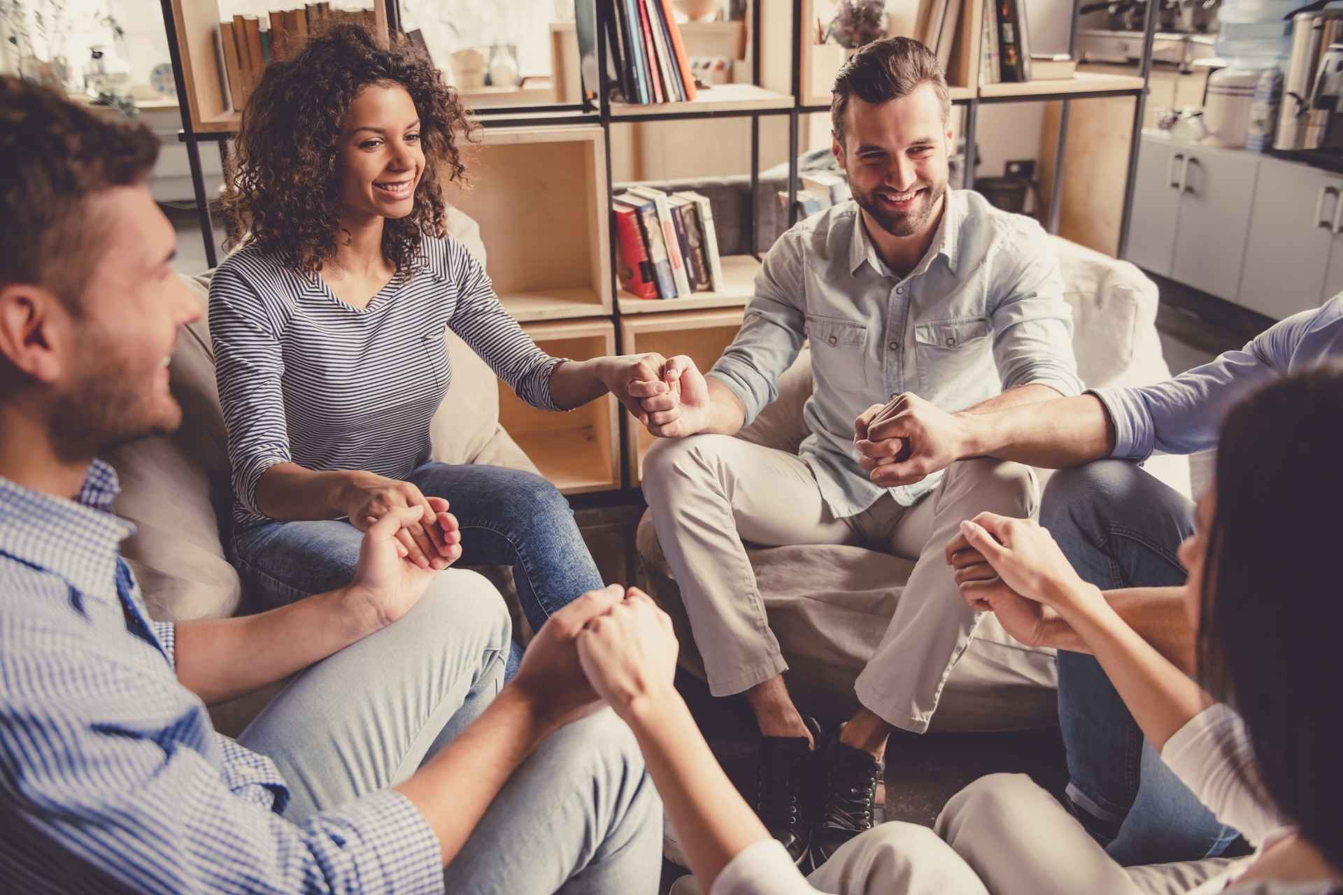 Adults supporting one another in a group setting after completing an intensive outpatient program. Image Title